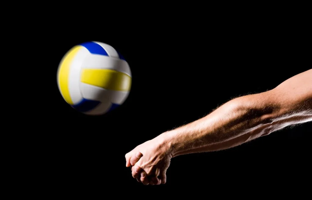 A volleyball player serving in a unique style