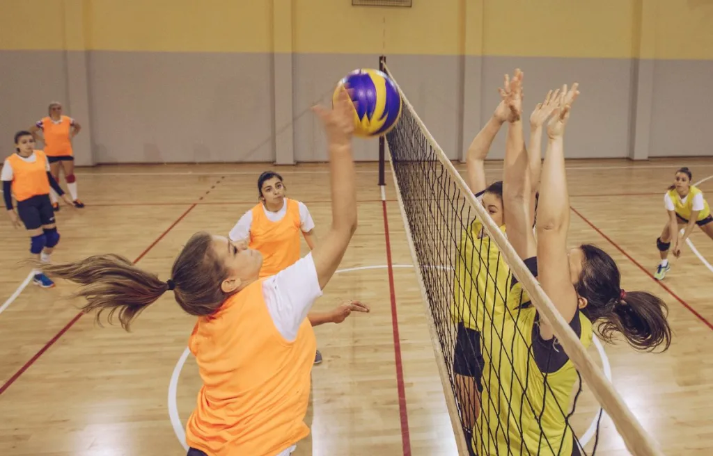 Players engaged in a volleyball match