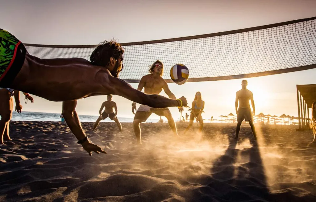 A volleyball player trying to pancake in beach volleyball match
