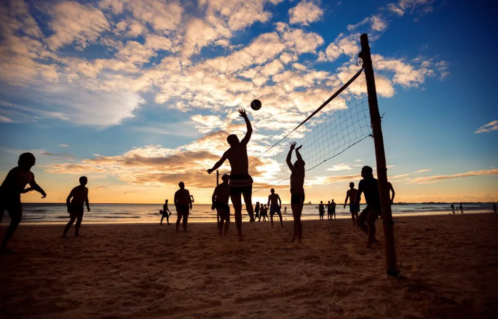 An overview of players playing on beach volleyball