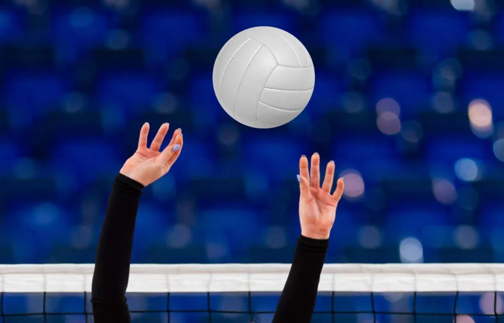 Volleyball player hands in the air for the focus
