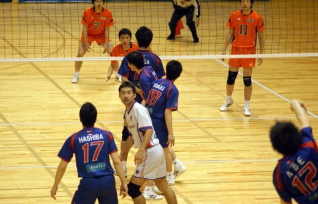A volleyball libero in action, wearing a unique jersey