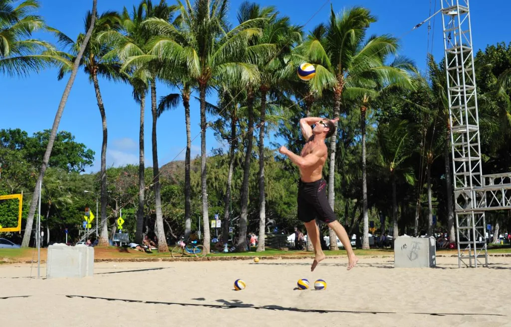 a college volleyball player doing a serve