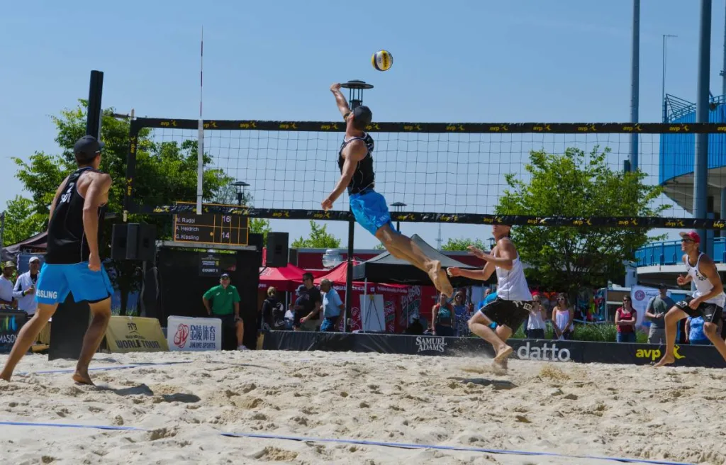 a volleyball player trying to avoid from holding the net