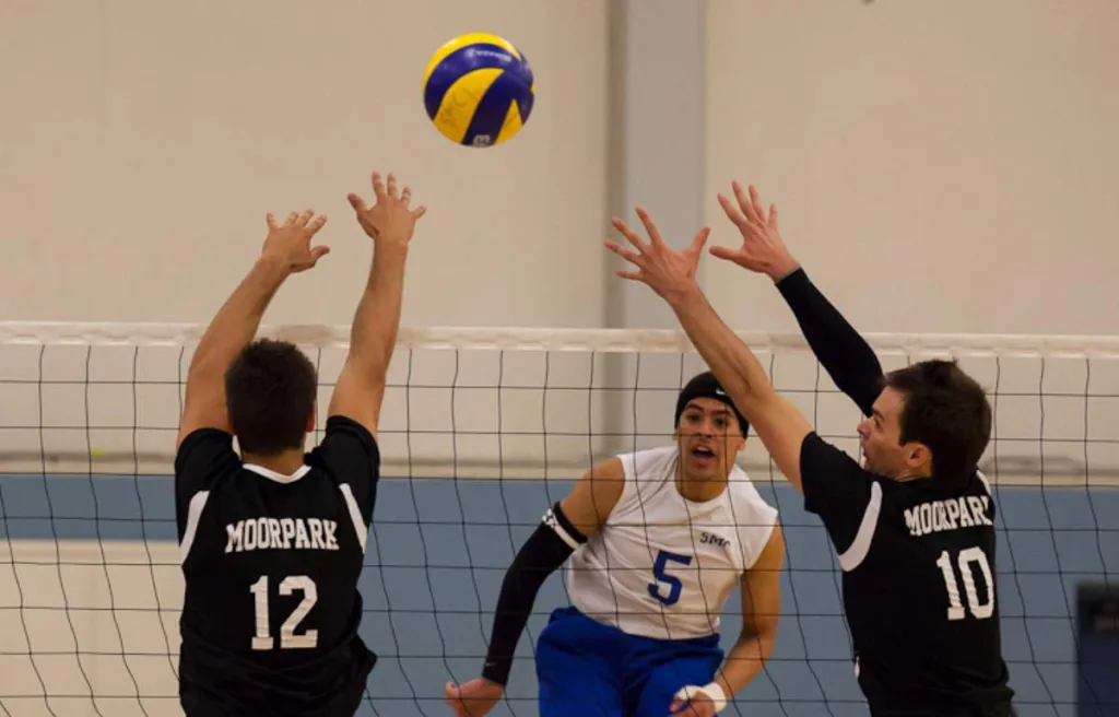middle blocker blocking the volleyball