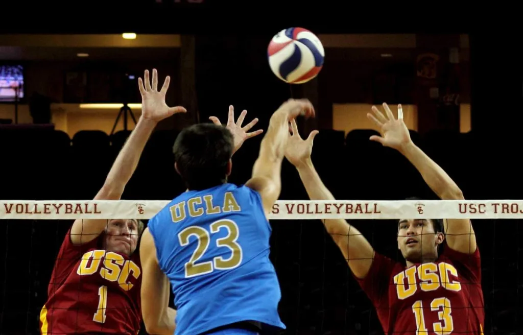 Players trying to block in intense volleyball match