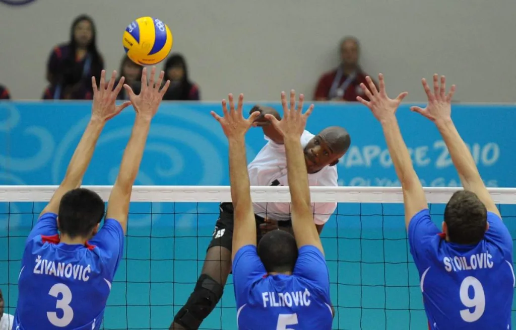 front row players trying to block a spike